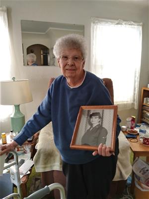 Geraldine Martino and a picture of her in the Air Force. Opens in new window